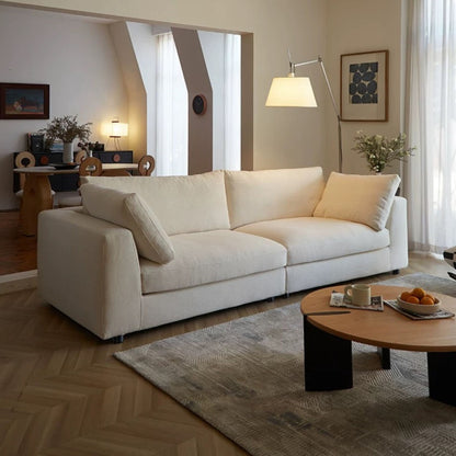 Claudia fabric sofa white in living room setting diagonal view