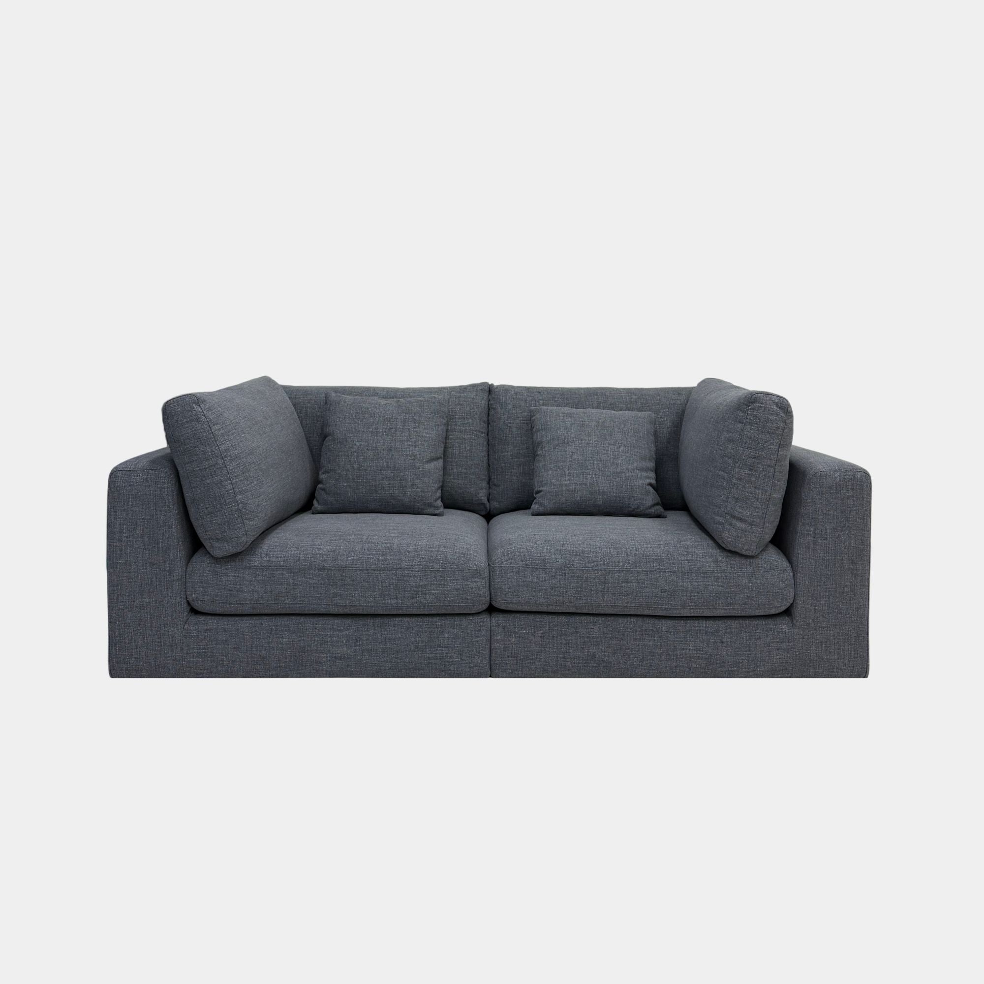 A modern two-seater sofa in textured black fabric, featuring four matching throw pillows, shown against a plain light gray background.