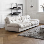 White sofa in a modern living room with a rug and decorative items.