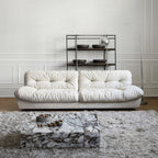 White sofa in a modern living room with a marble coffee table and decorative items.