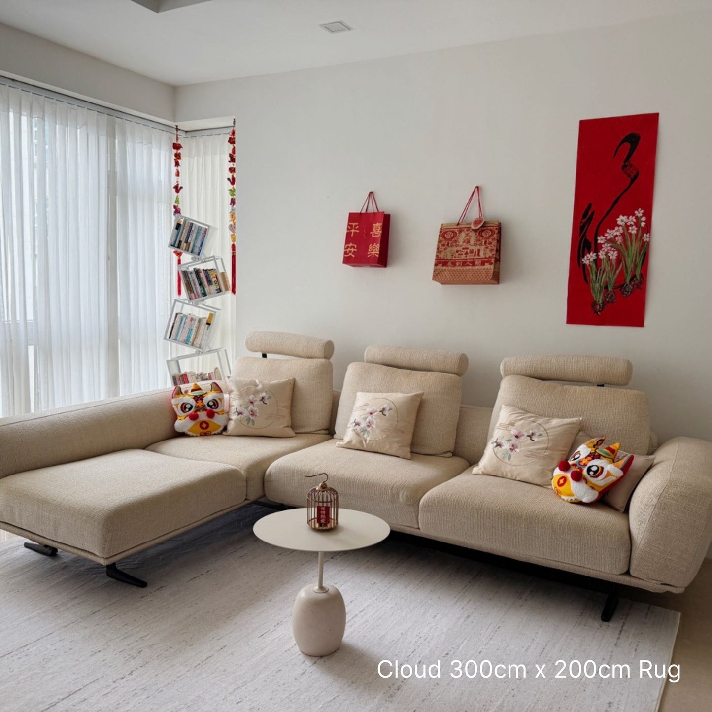 Beige sectional sofa in a living room with decorative pillows and a small table.