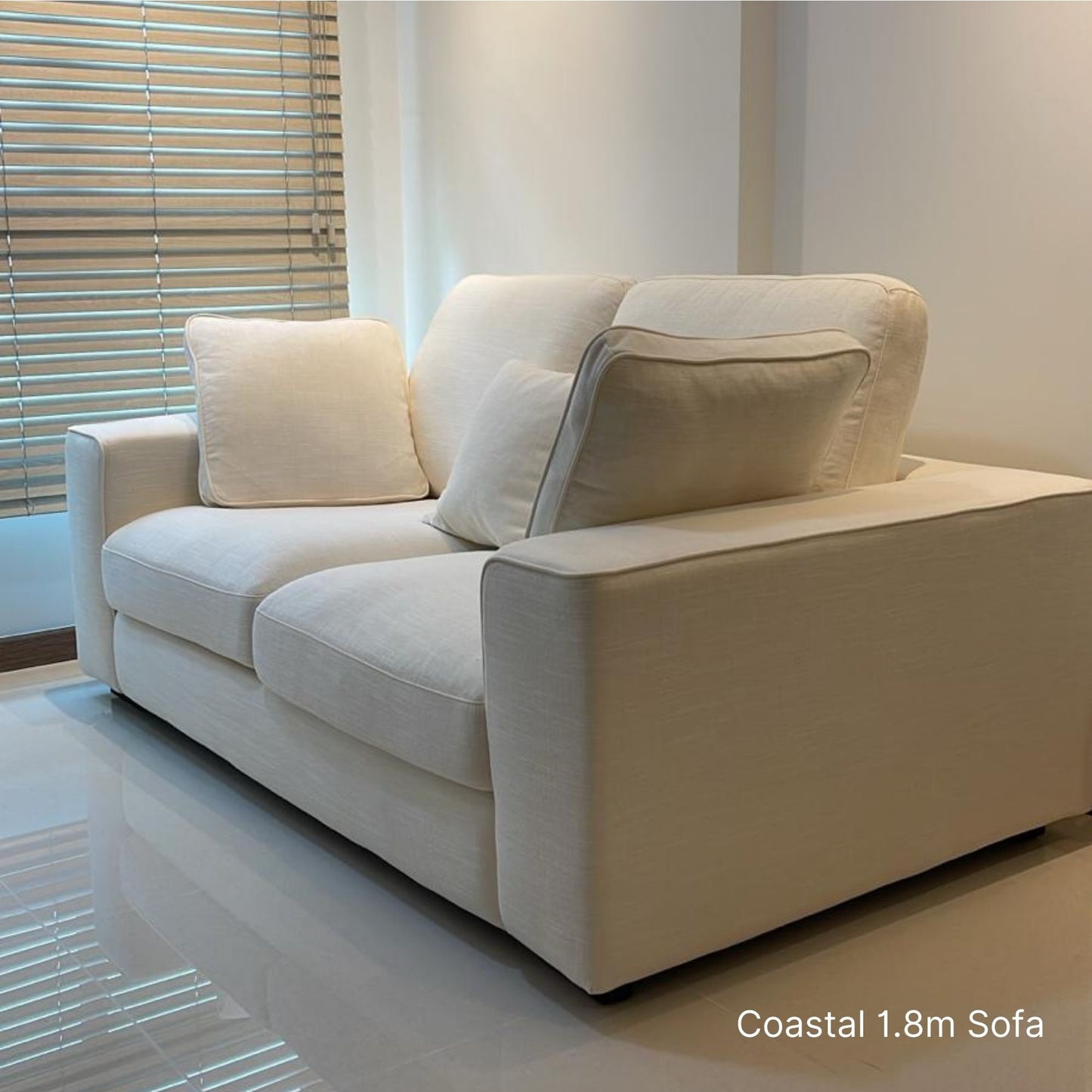 White 180cm 2 seater Coastal fabric sofa with cushions in a modern living room setting