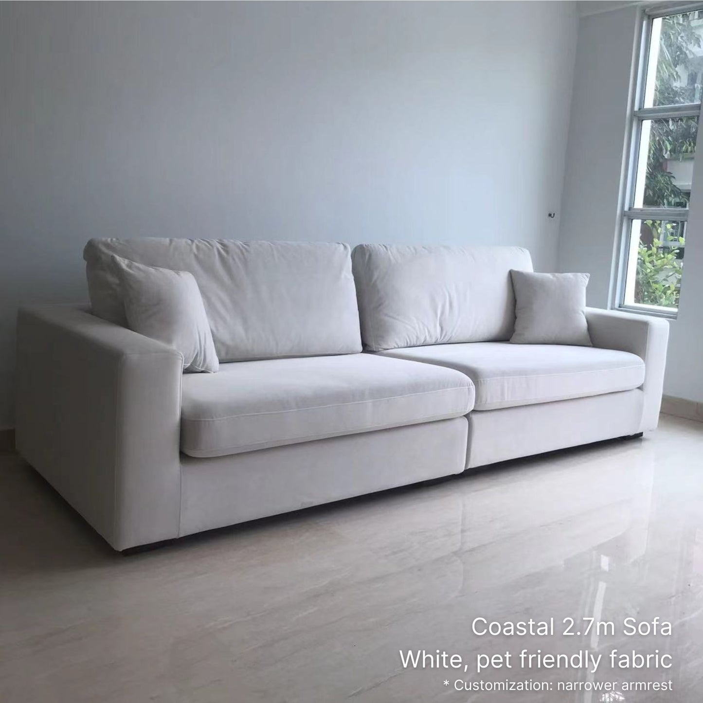 White pet friendly fabric 4 seater Coastal sofa in a minimalistic room with a window in the background