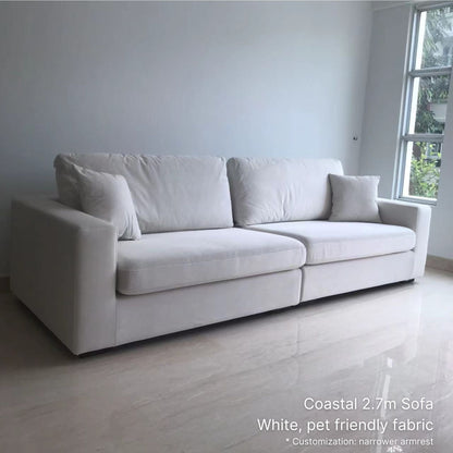 White pet friendly fabric 4 seater Coastal sofa in a minimalistic room with a window in the background