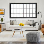 Modern living room with white sofa, coffee table, and decorative elements.
