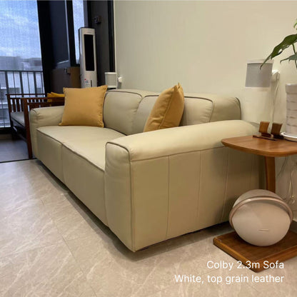 White Colby 3 seater 220cm half leather sofa with yellow cushions in a living room setting.