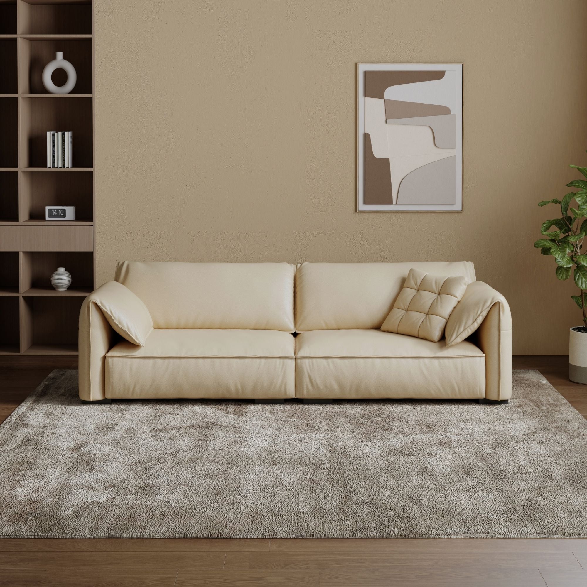 Beige sofa in a living room with a rug, bookshelf, and abstract painting.