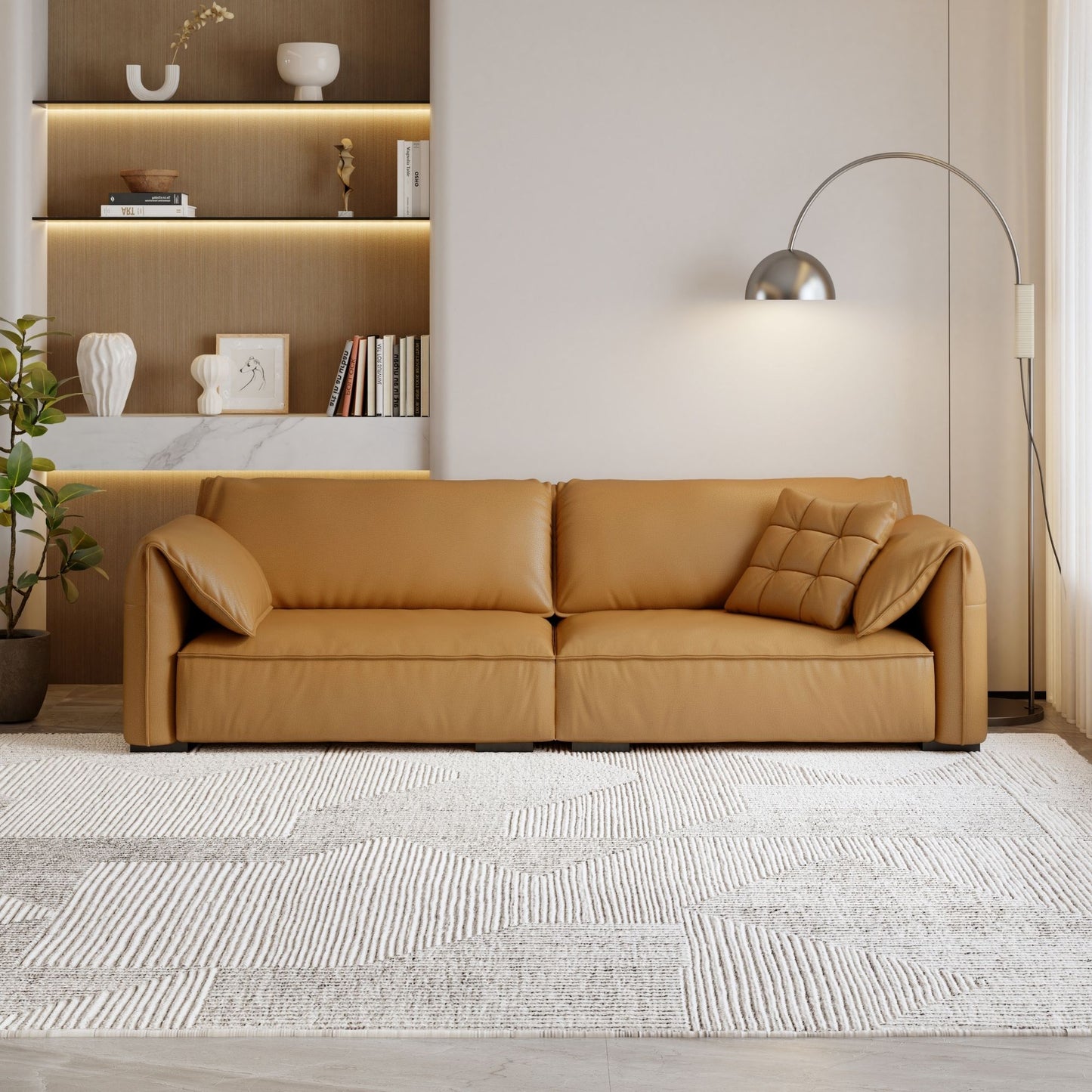 Tan leather sofa in a modern living room with a rug and wall shelves.