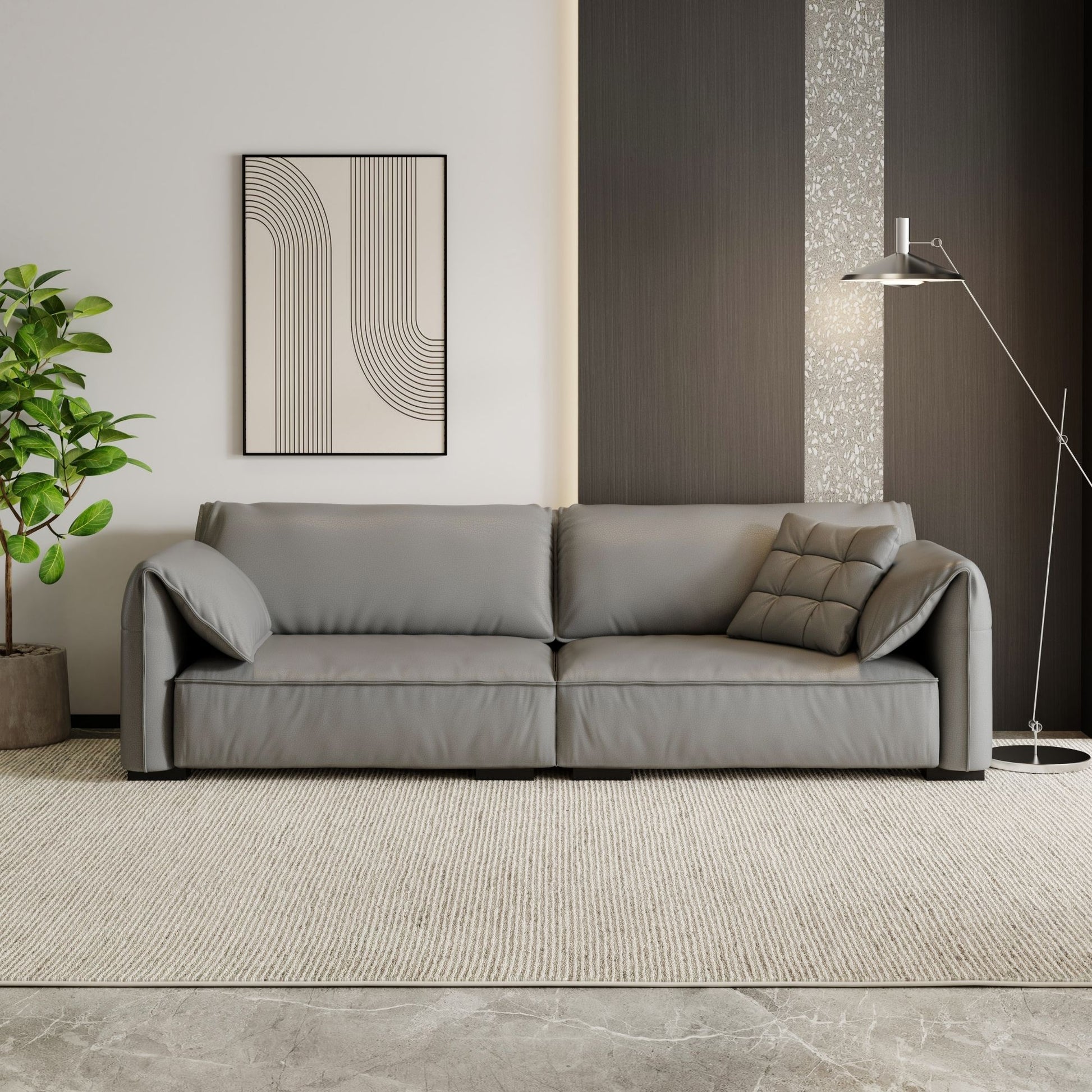 Gray sofa in a modern living room with a plant and abstract art on the wall.