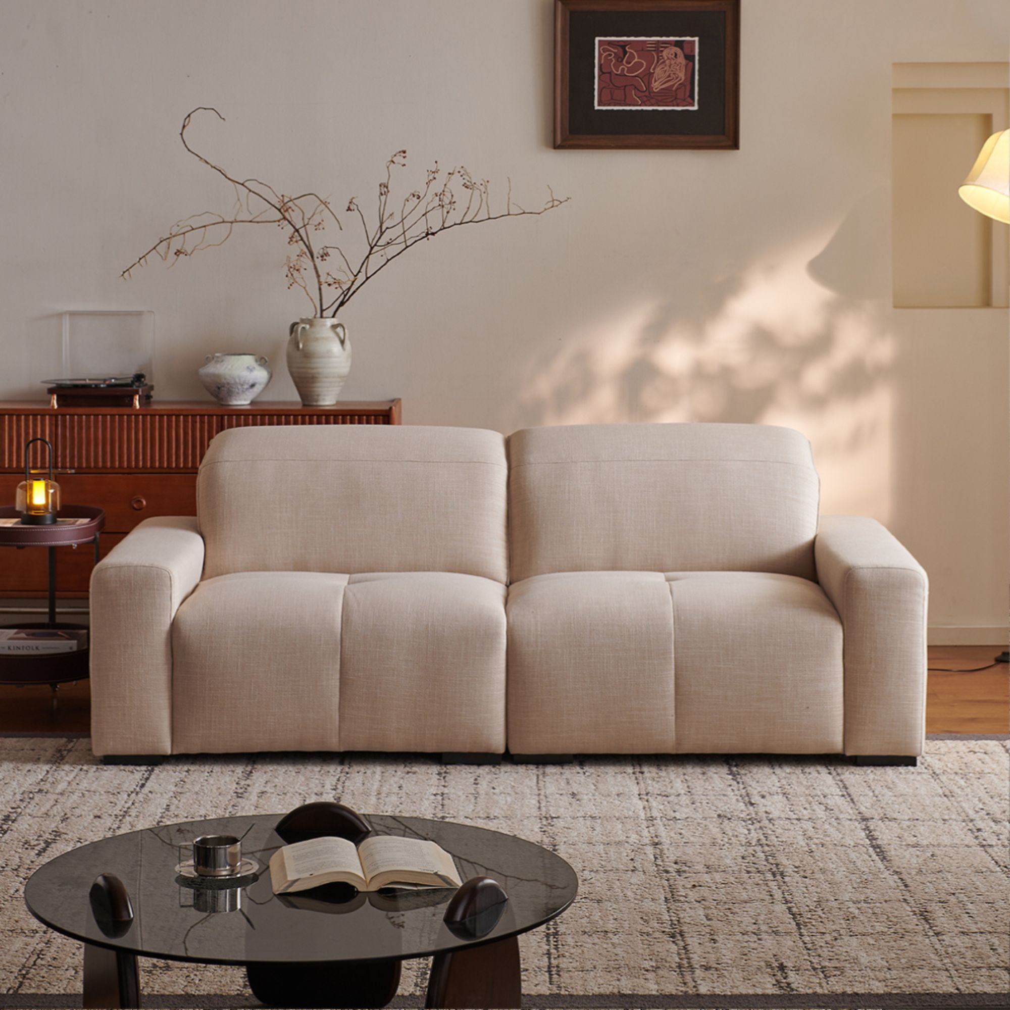Beige sofa in a living room with a coffee table and decorative items.