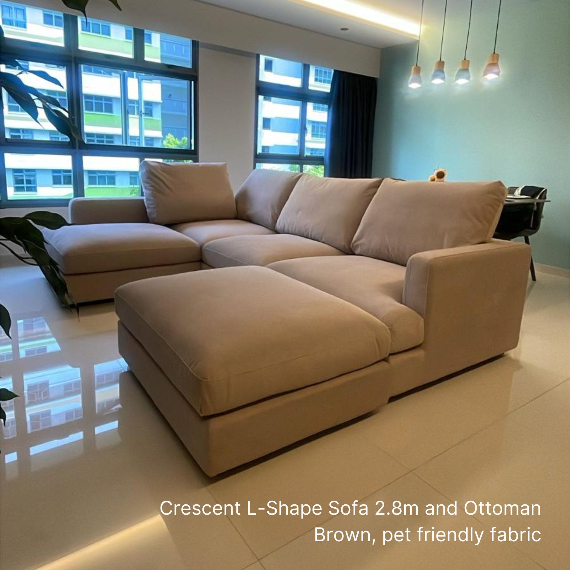 4 seater Crescent L-shaped sectional sofa with matching ottoman in brown pet friendly leather