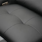 Close-up of a black sofa seat with stitching details
