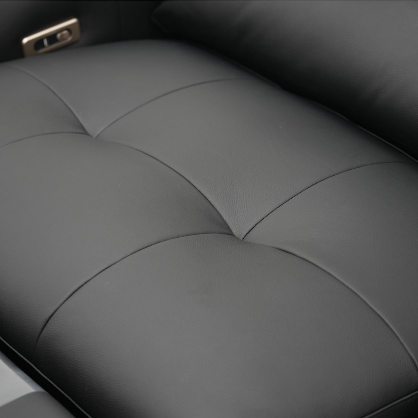 Close-up of a black sofa seat with stitching details