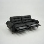 Black leather sofa with reclining feature on a white background