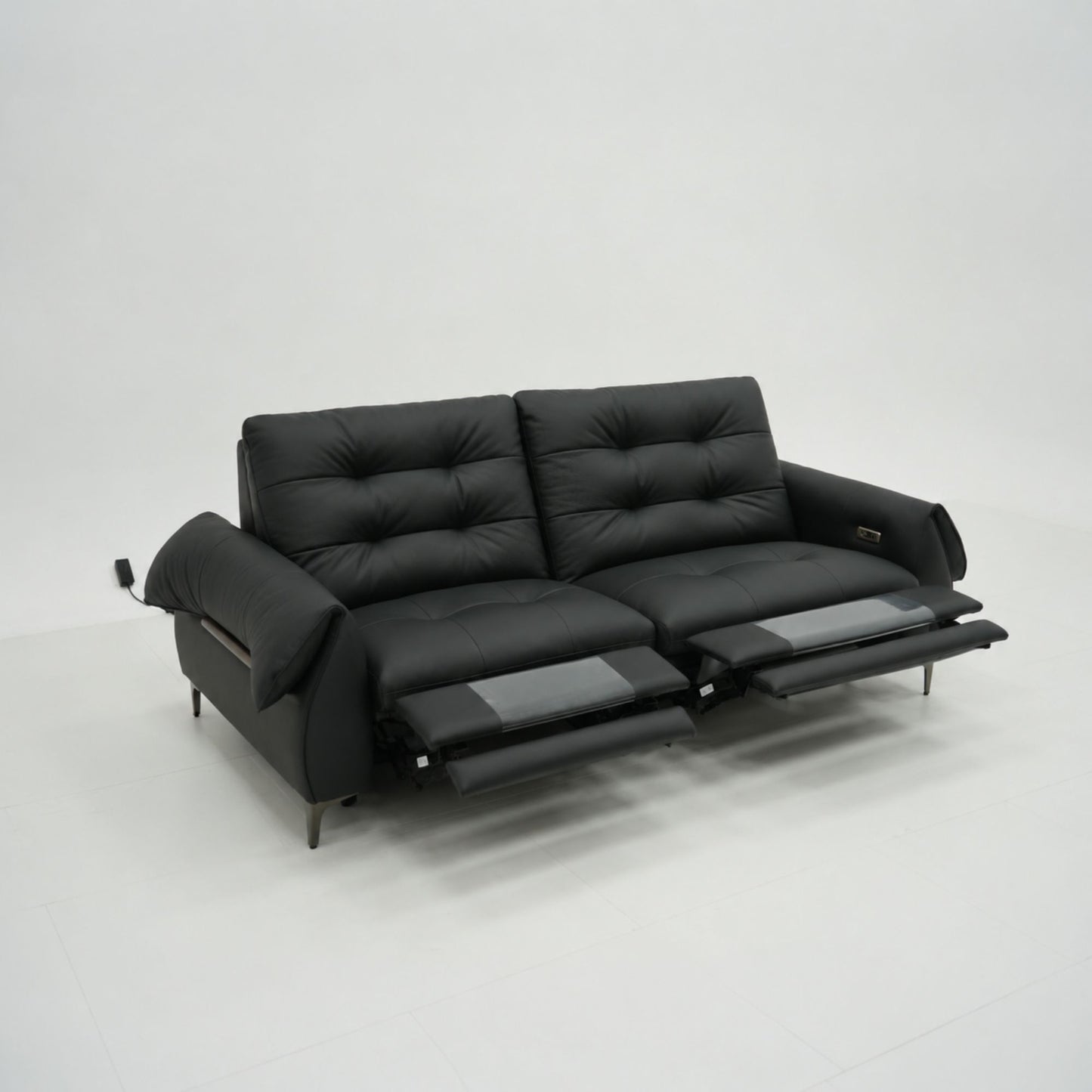 Black leather sofa with reclining feature on a white background