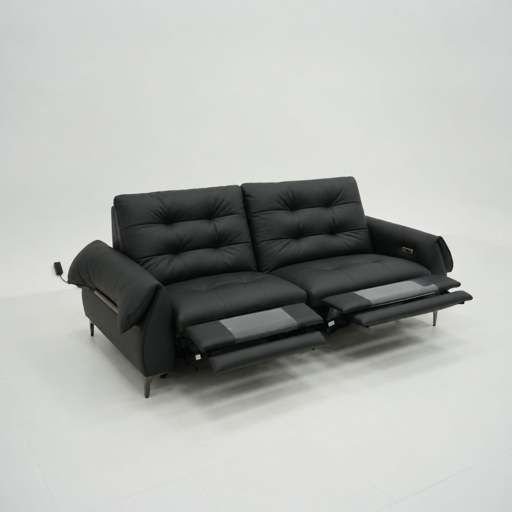 Black leather sofa with reclining feature on a white background
