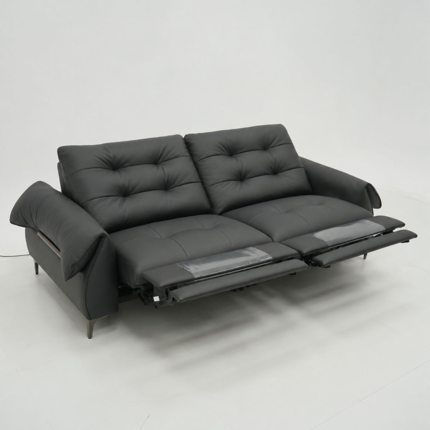 Black sofa with reclining feature on a white background