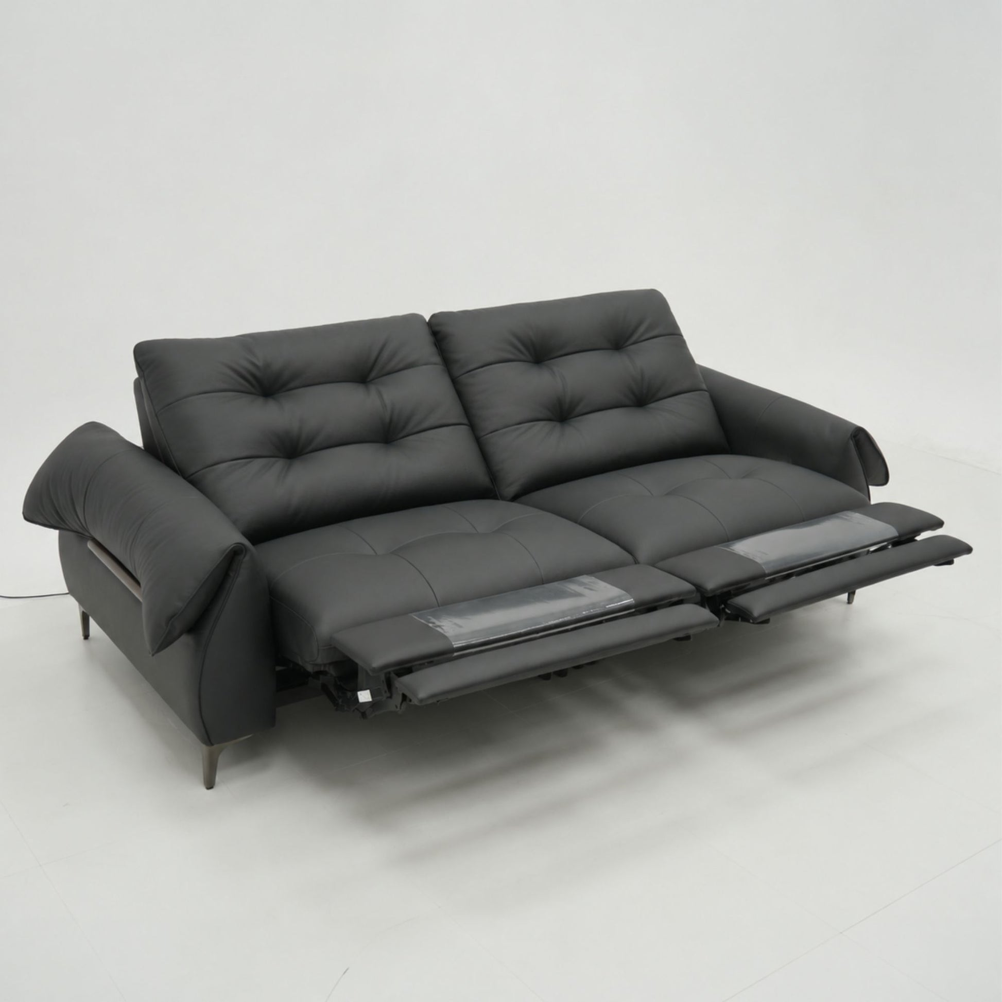 Black sofa with reclining feature on a white background