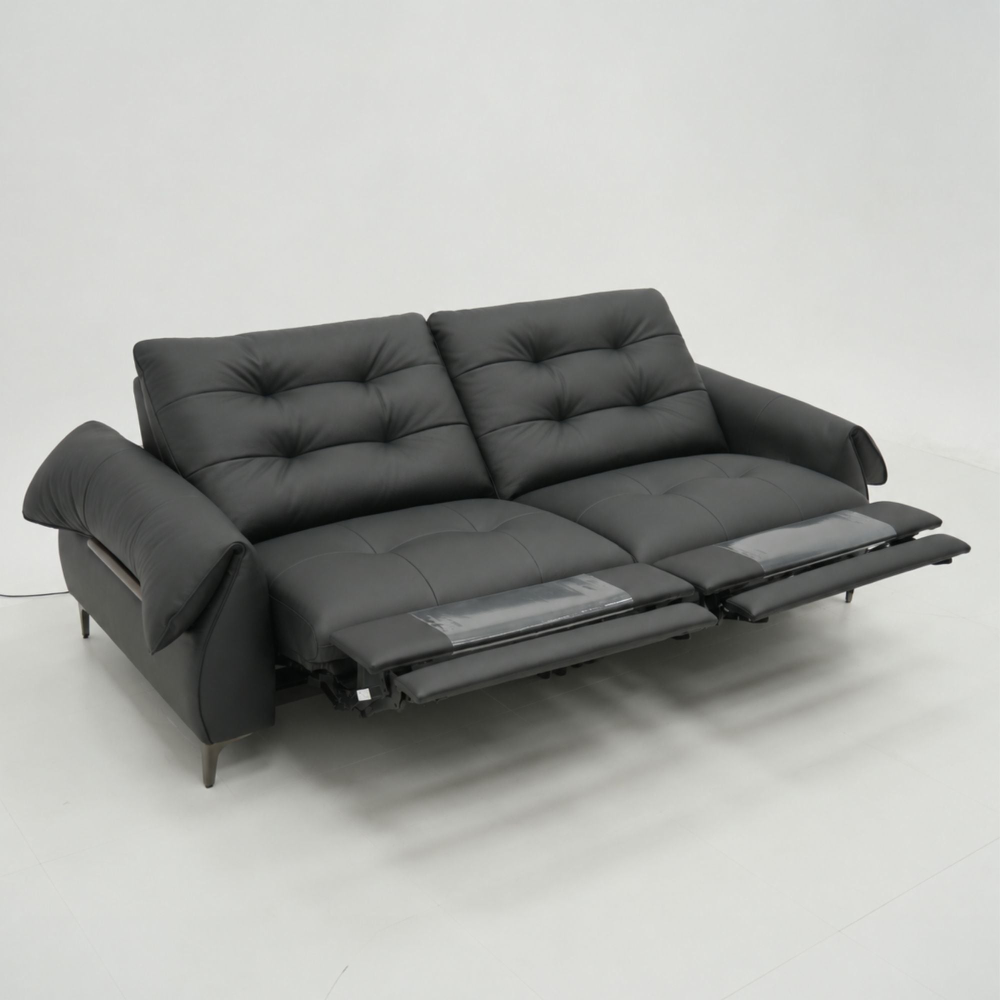 Black sofa with reclining feature on a white background