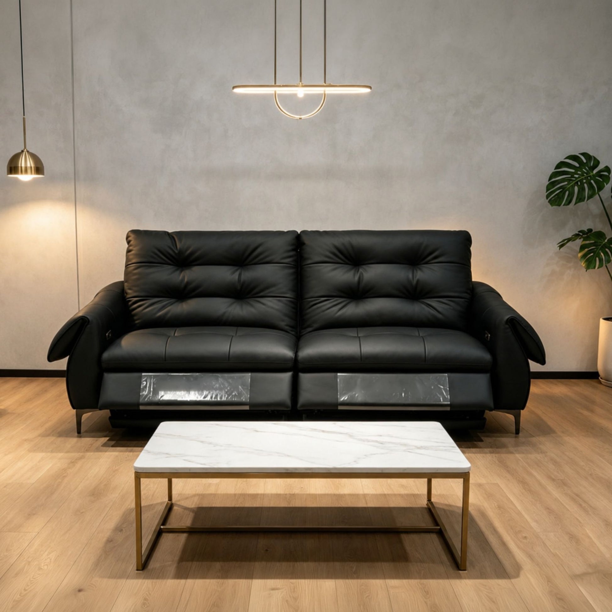 Black leather sofa in a modern living room with a marble coffee table.