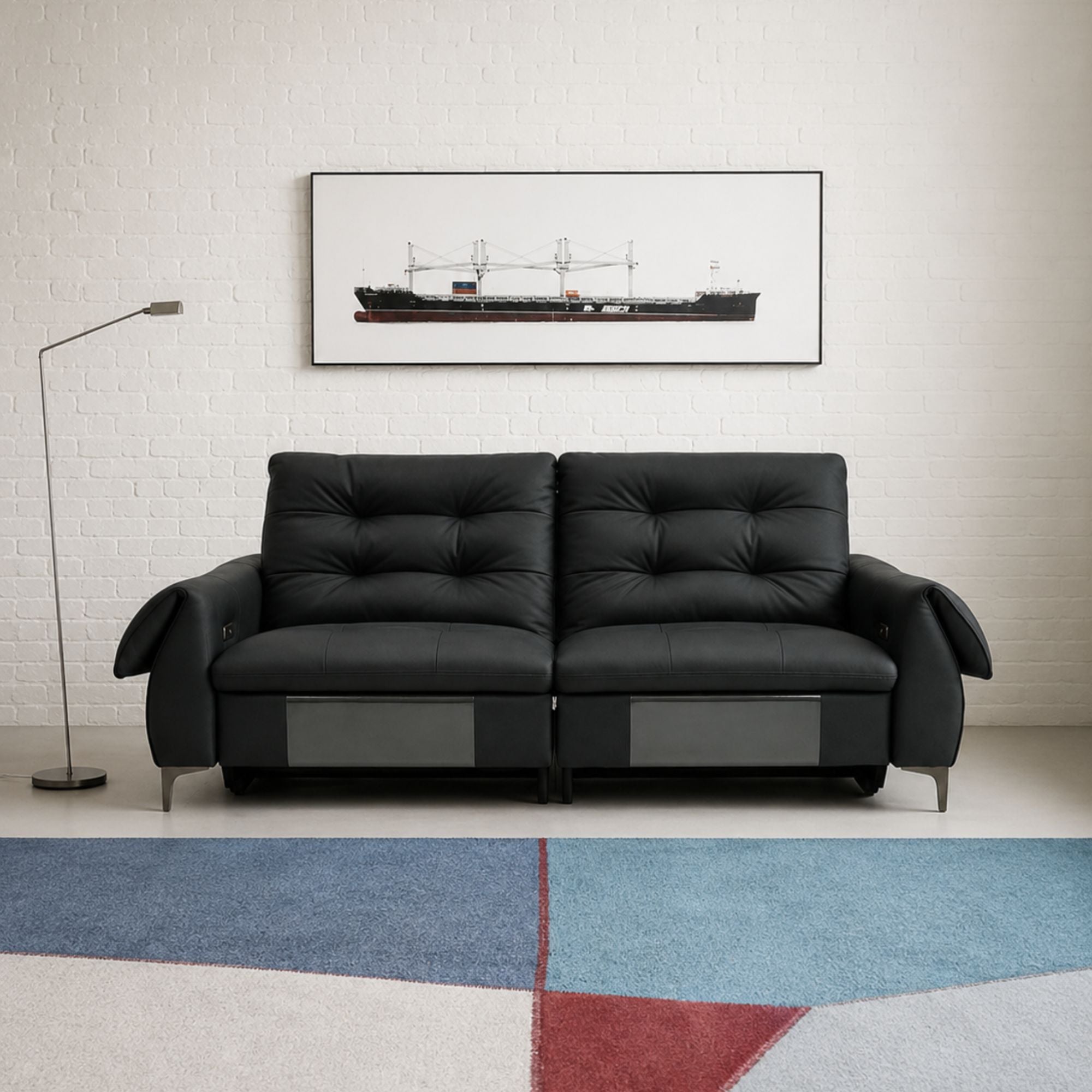 Black leather sofa in a modern living room with a marble coffee table.