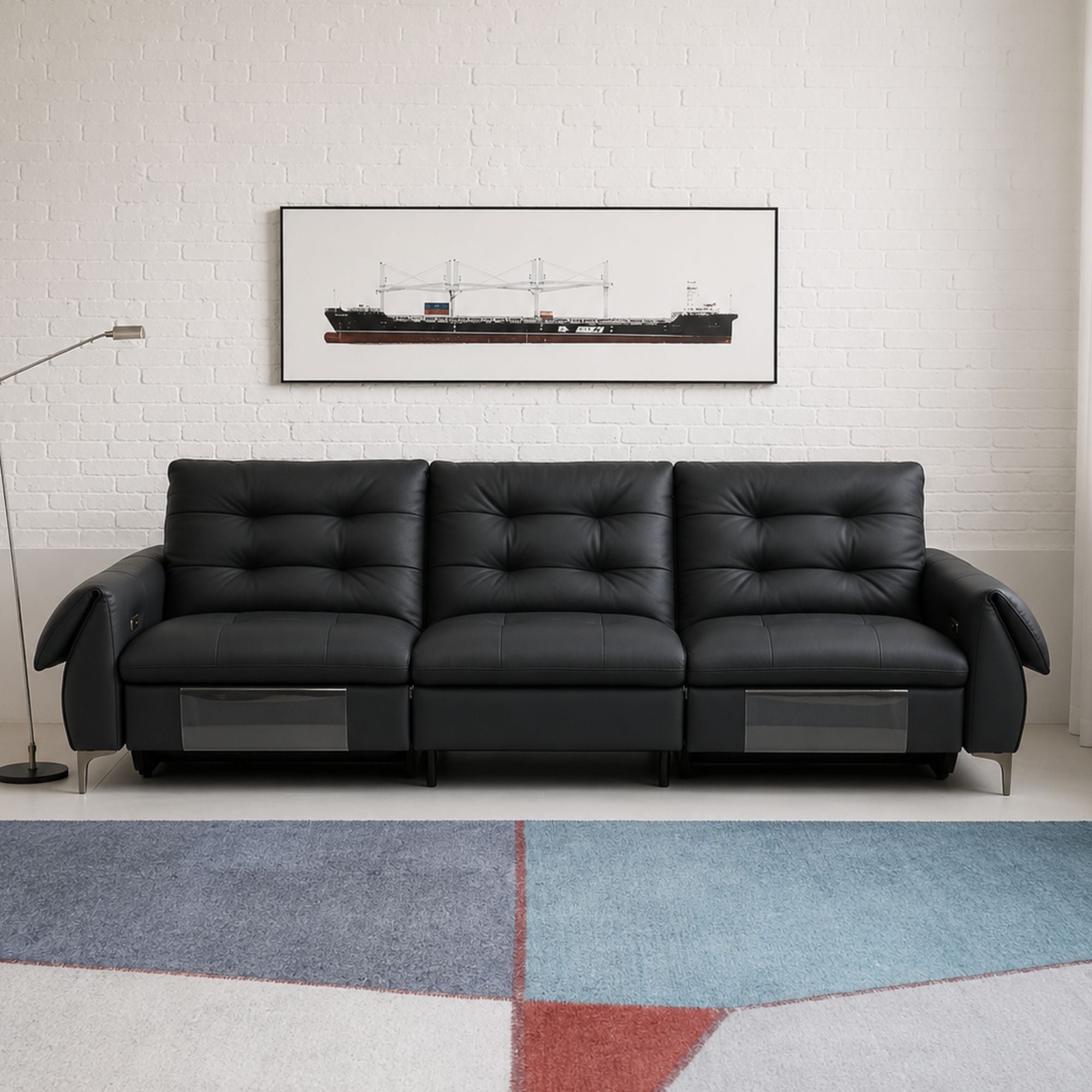 Modern living room with a black leather sofa and wooden coffee table.