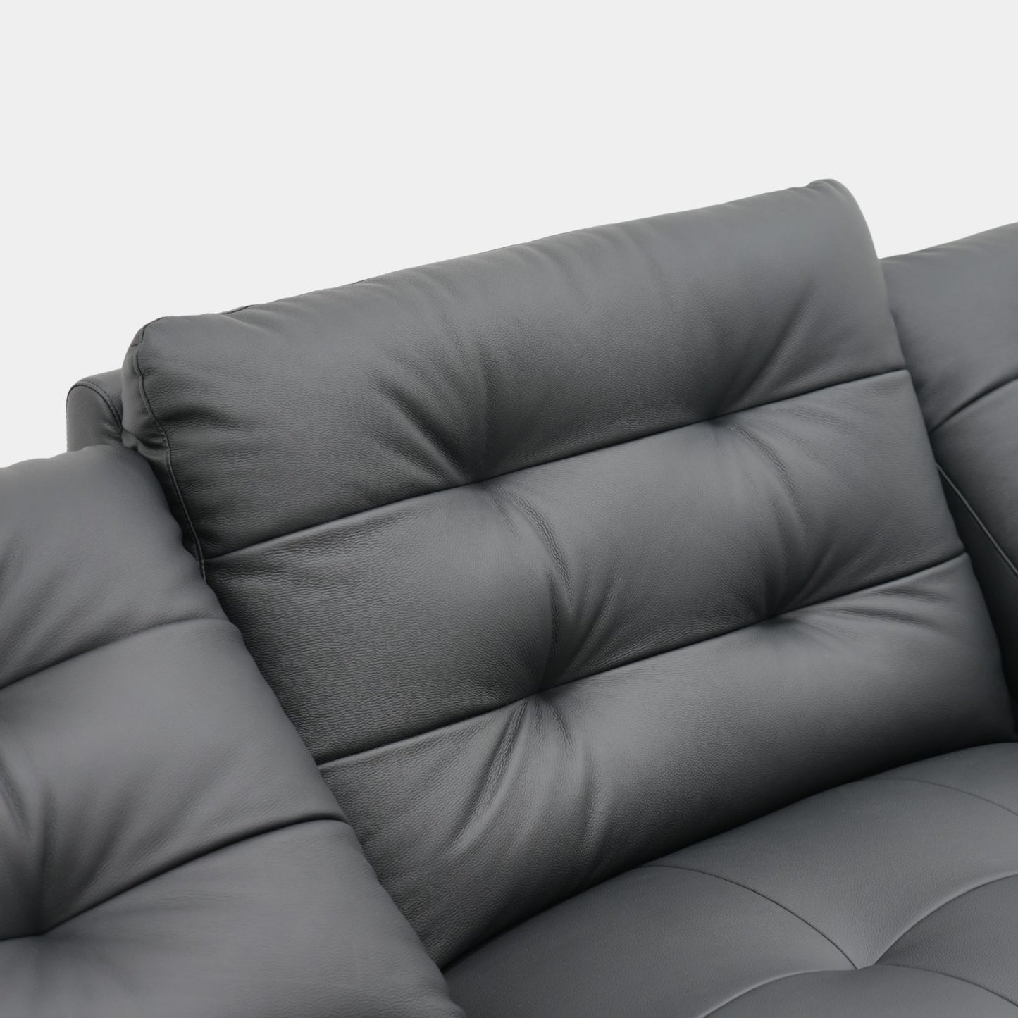 Black leather sofa close up of its backrest design on a white background