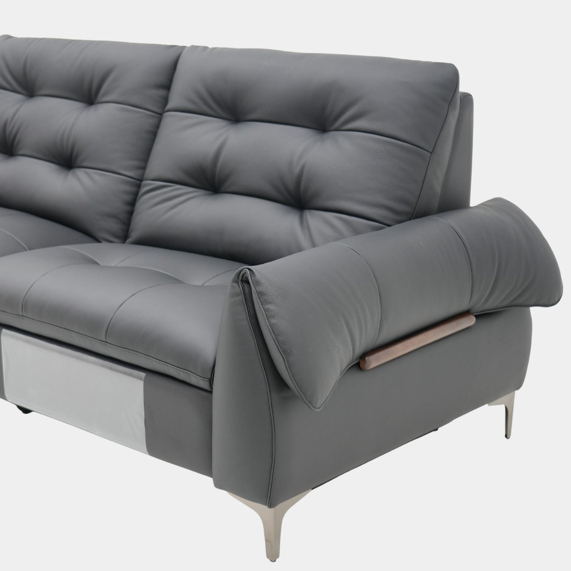 Black recliner sofa with a tufted design on a white background
