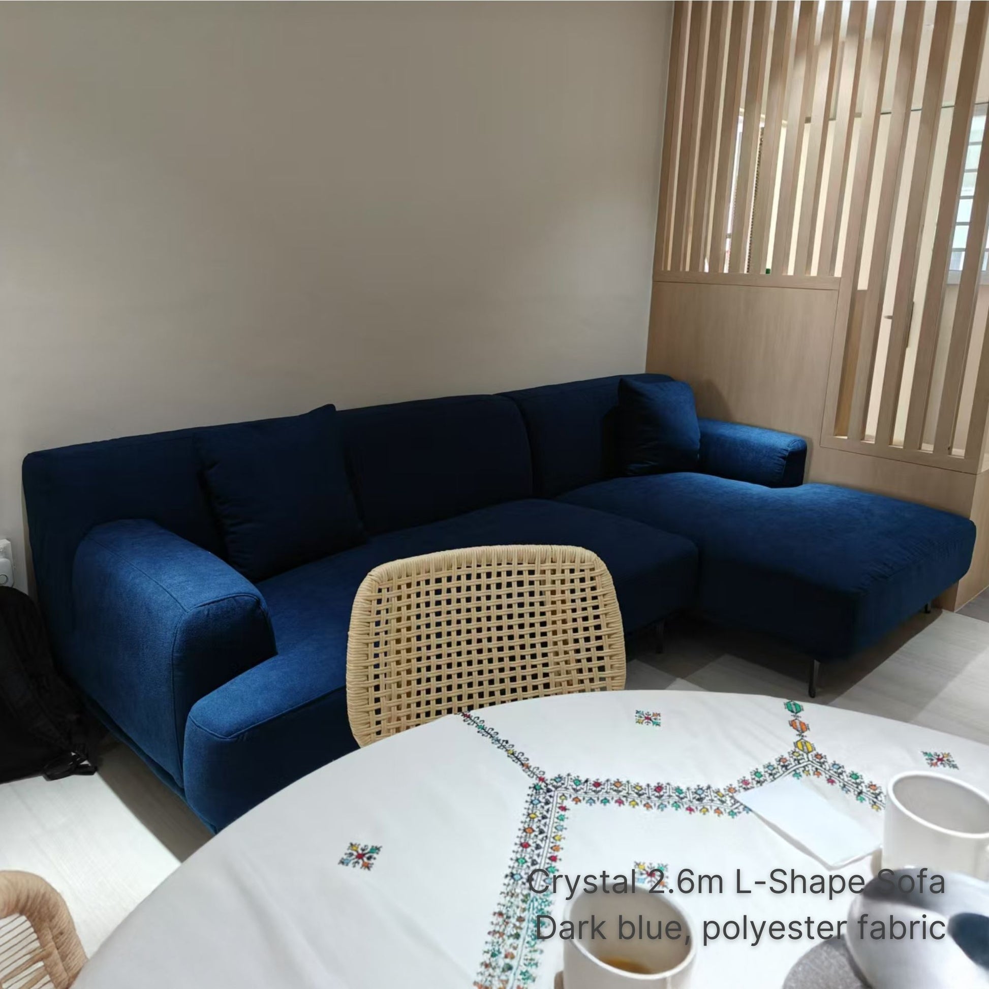 Dark blue 4 seater 280cm Crystal L-shaped sofa in a living room setting with a table and chairs.