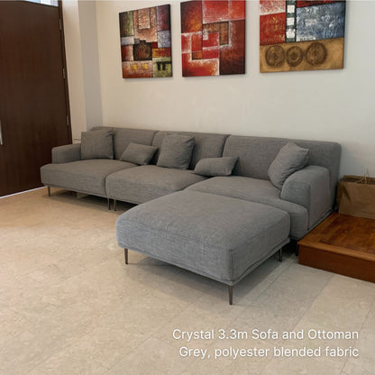 Crystal 5 seater 330cm gray sofa with ottoman in a room with abstract art on the wall.