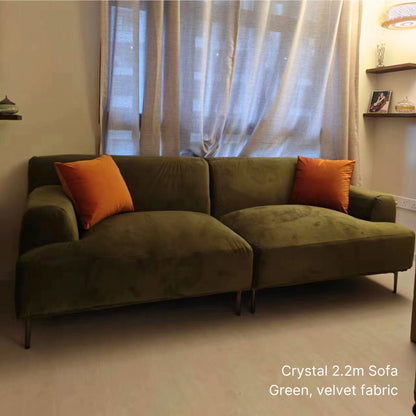 3 seater 220cm Crystal green velvet sofa with orange cushions in a room setting