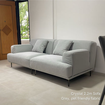 220cm 3 seater Crystal gray pet friendly fabric sofa in a room with a wooden door and window.