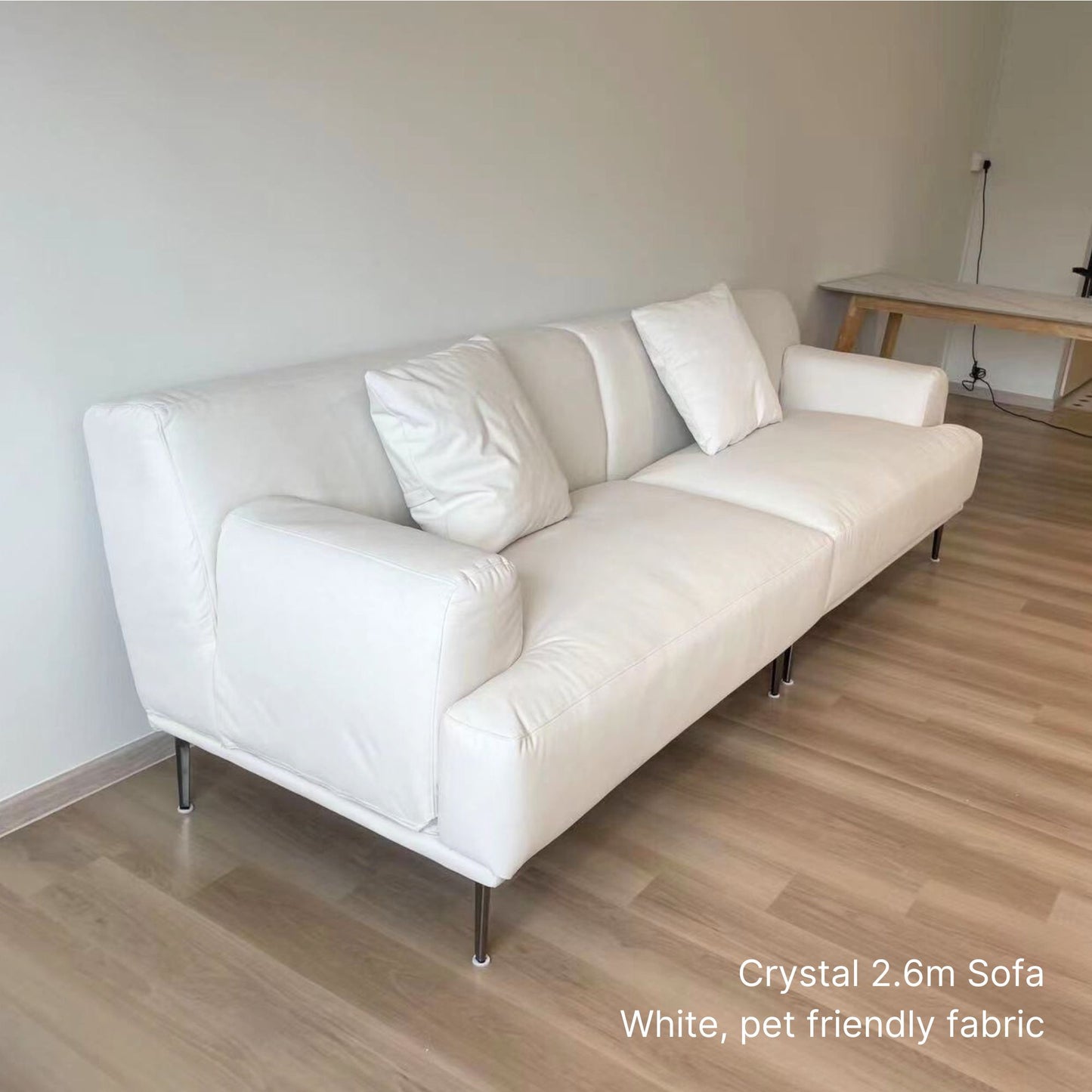 4 seater Crystal 260cm white pet friendly fabric sofa on a wooden floor.