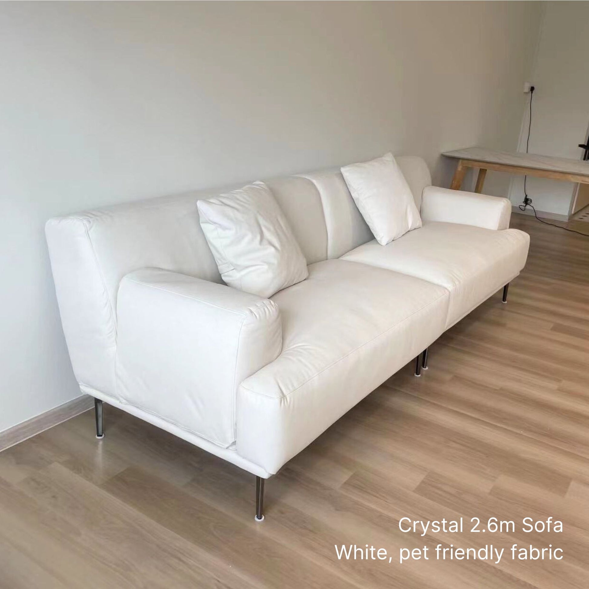 4 seater Crystal 260cm white pet friendly fabric sofa on a wooden floor.