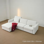White Cubis sofa with ottoman in a minimalistic room