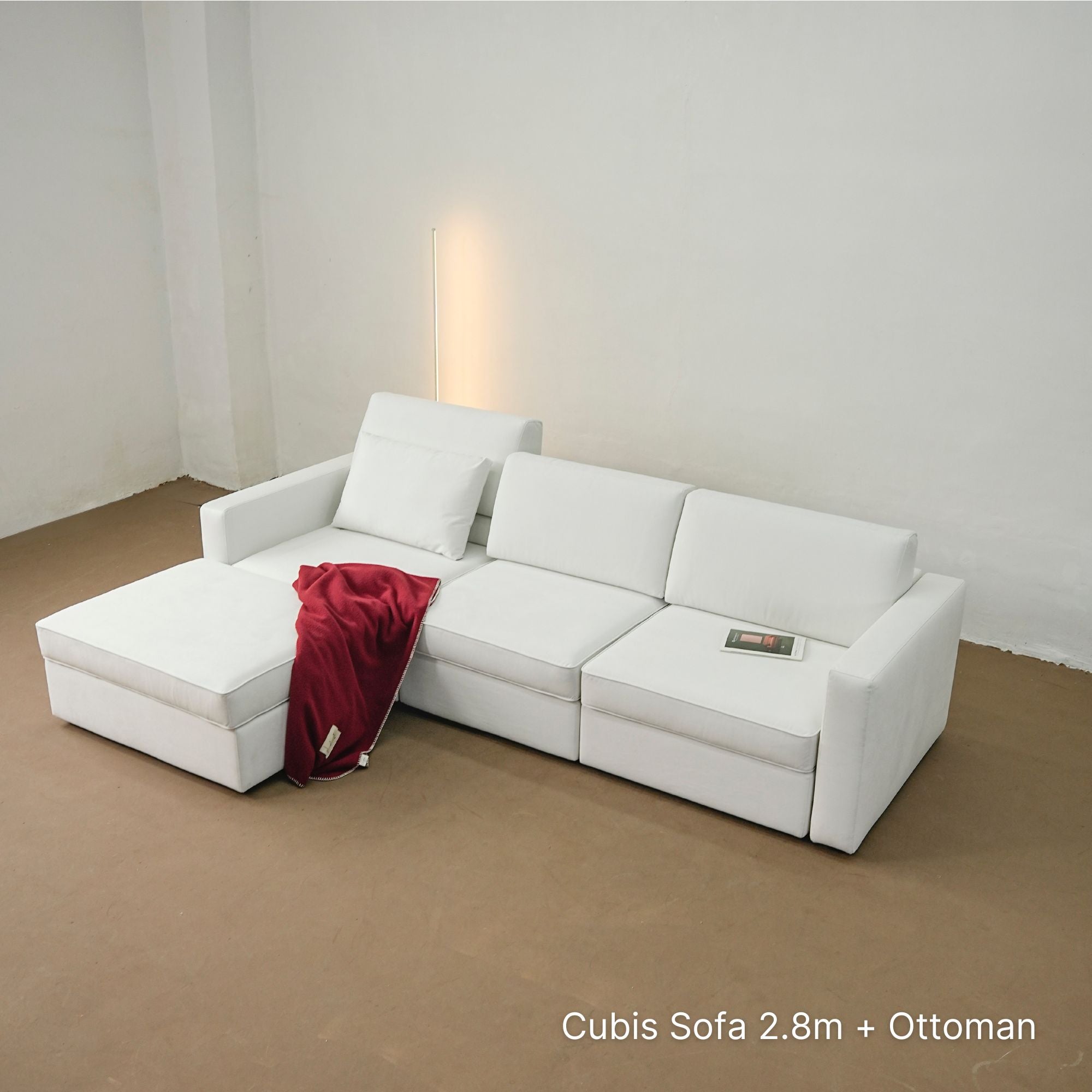 White Cubis sofa with ottoman in a minimalistic room