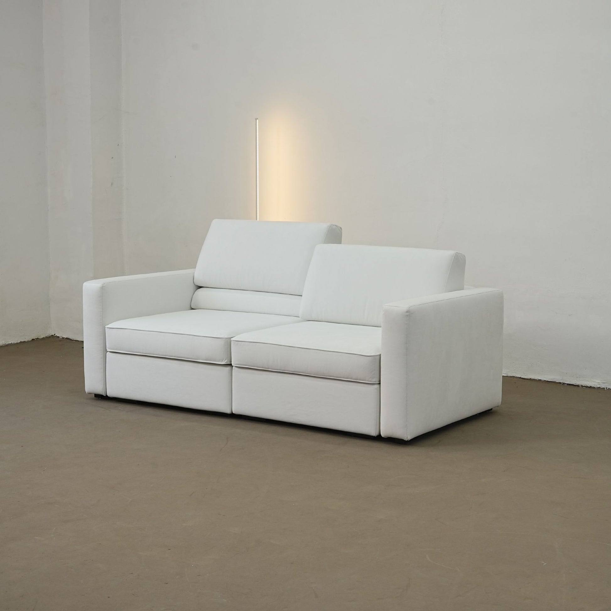 White sofa in a minimalistic room with a neutral color palette