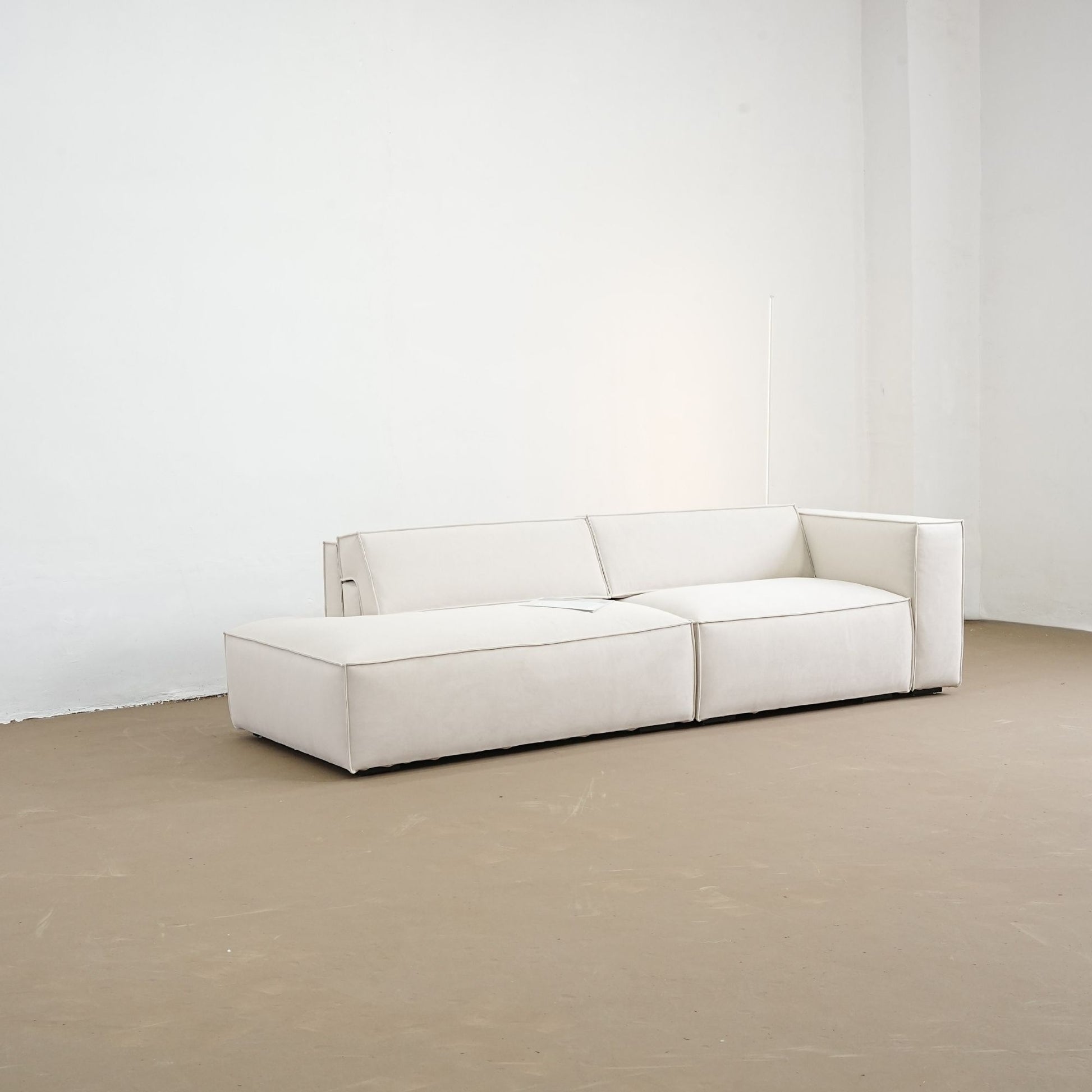 diagonal view of adjustable backrest sofa with one arm one the factory floor