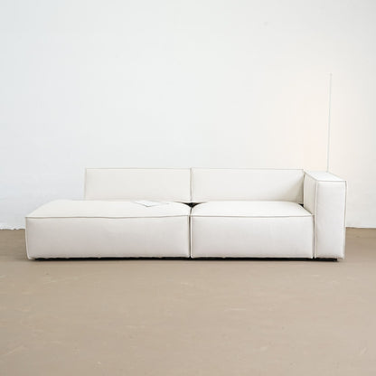 White modular sofa on a beige floor with a white wall background