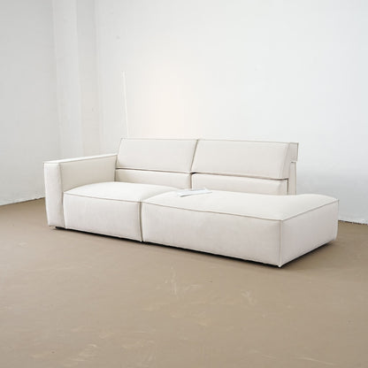 White sofa on a beige floor with a white wall background