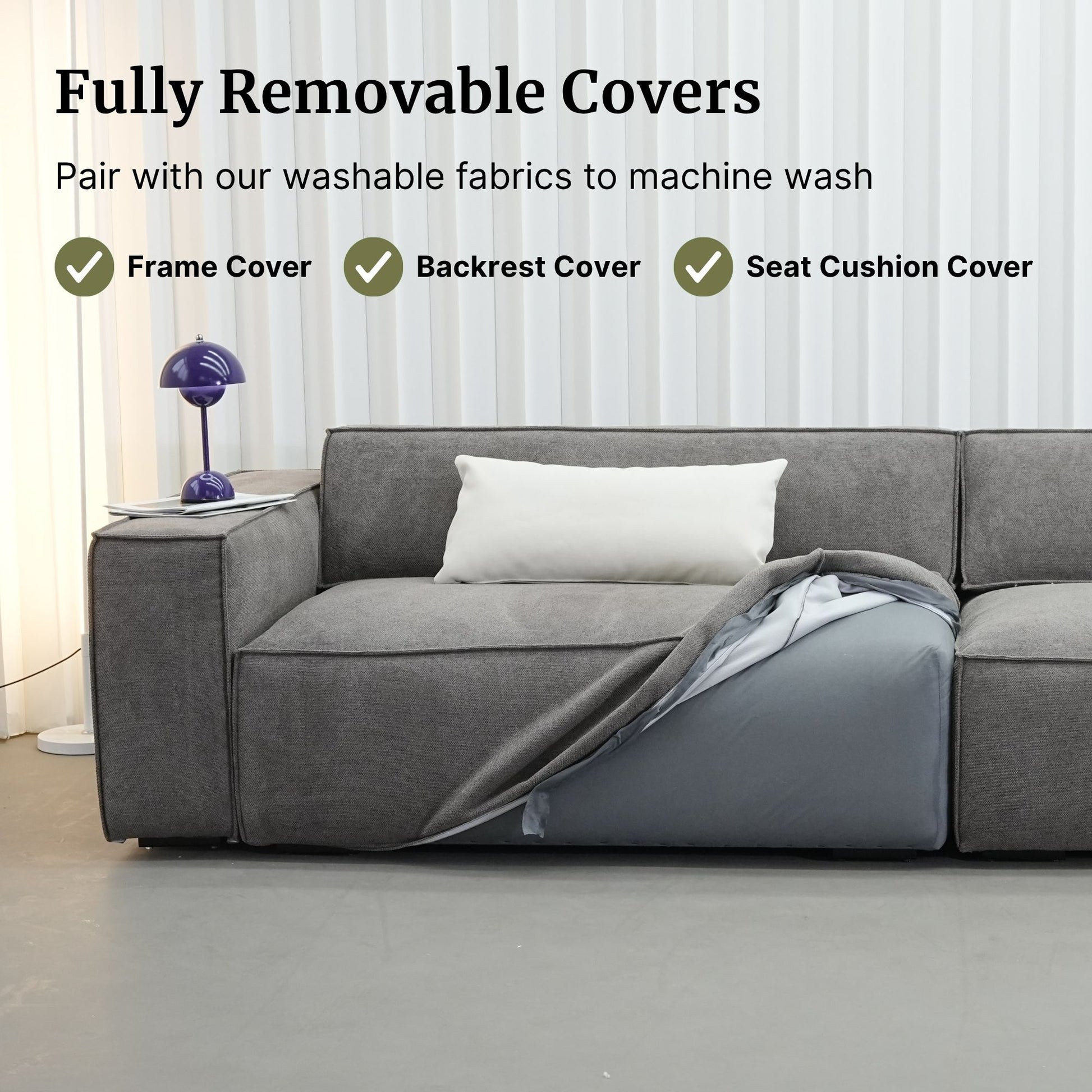 Gray sectional sofa with a blanket draped over it, featuring text about fully removable covers.