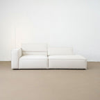 White modular sofa against a white wall on a beige floor
