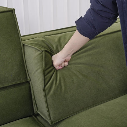 Hand pressing down on the adjustable backrest portion for Cubix fabric adjustable backrest sofa in green pet friendly fabric.