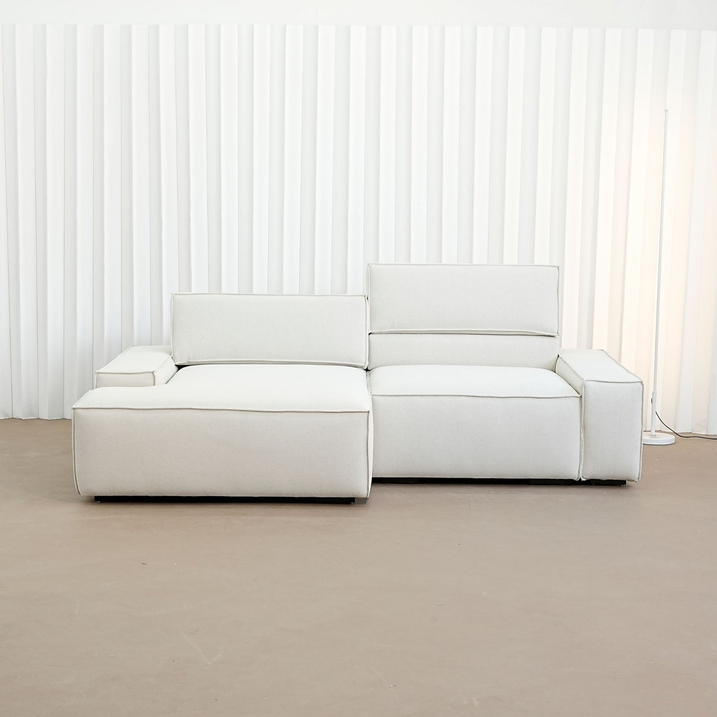 cubix fabric adjustable backrest l-shaped sectional sofa left chaise front view in factory showroom