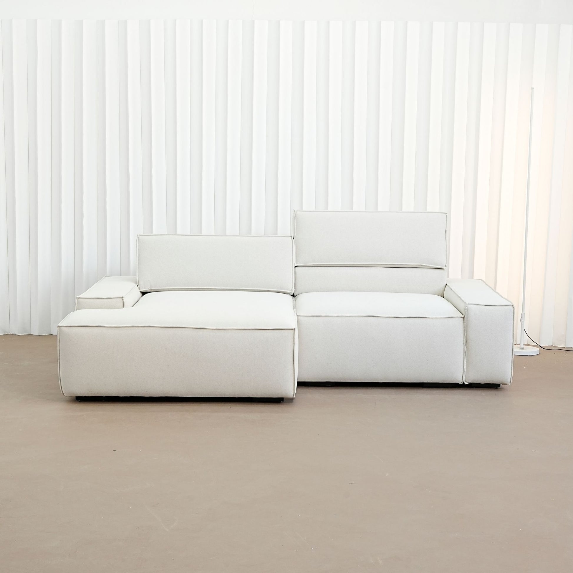 cubix fabric adjustable backrest l-shaped sectional sofa left chaise front view in factory showroom