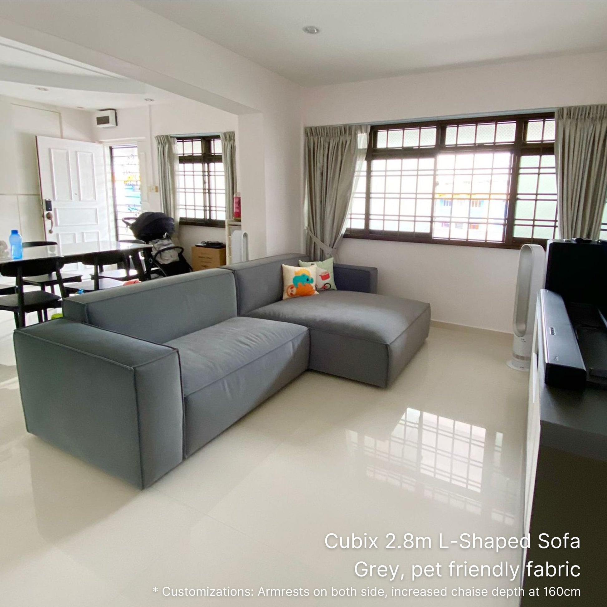 Cubix gray pet friendly fabric 4 seater L-shaped sofa in a living room with white walls and tiled floor.