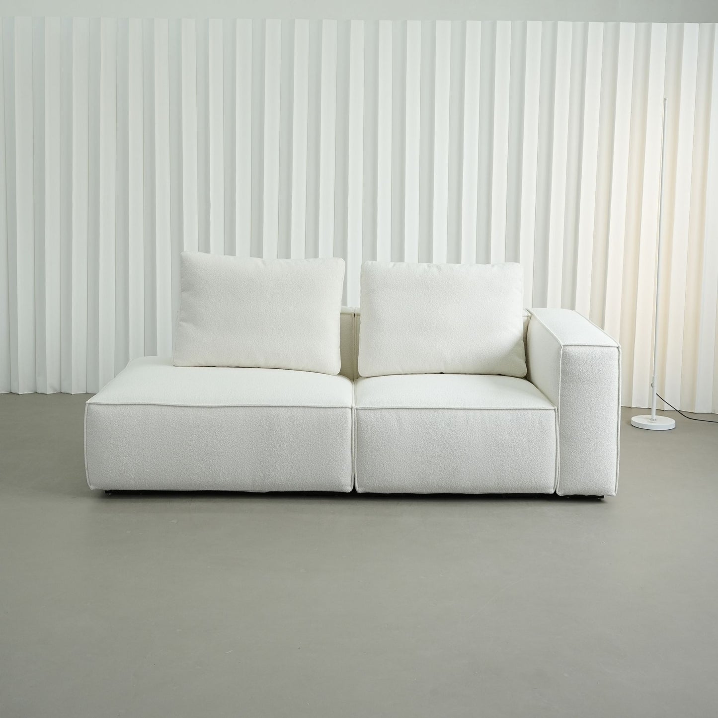White sofa against a white paneled wall