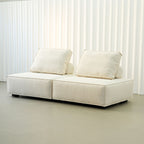 White sofa with cushions on a plain background