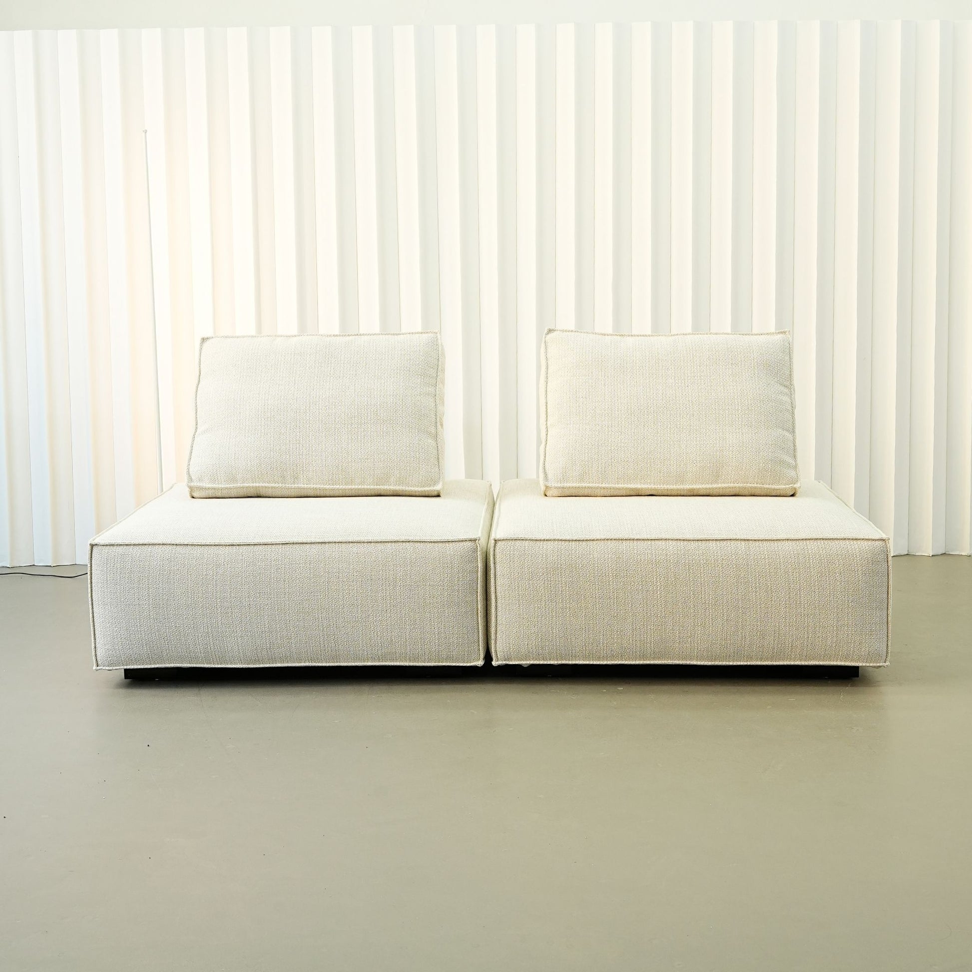 White Cublox fabric sofa against a white paneled background