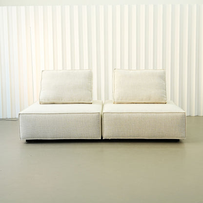 White Cublox fabric sofa against a white paneled background